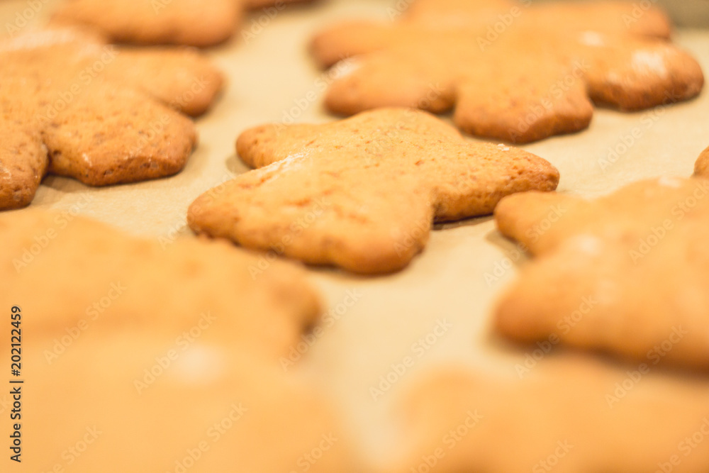 Ginger biscuits lie on a baking sheet. Cookies on baking paper. Selective focus. Ginger biscuits lie on a baking sheet. Cookies on baking paper. Selective focus.