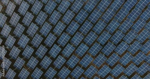 Aerial view of Solar Panels Farm (solar cell) with sunlight.Drone flight fly over solar panels field renewable green alternative energy concept in Thailand.