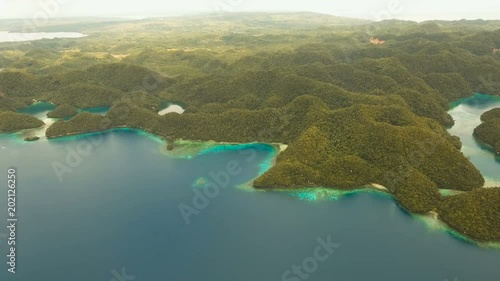 Aerial view: Bucas Grande Island, Sohoton Cove. Philippines. Tropical sea bay and lagoon, beach. Tropical landscape hill, clouds and mountains rocks with rainforest. Azure water of lagoon. Shore photo