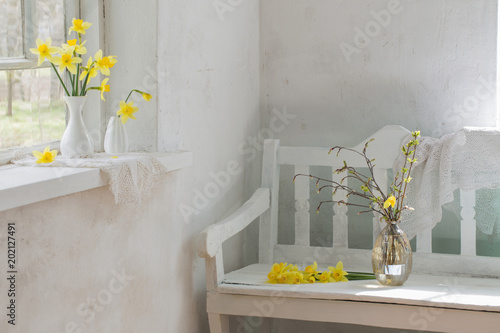 Fototapeta Naklejka Na Ścianę i Meble -  yellow spring flowers in white vintage interior