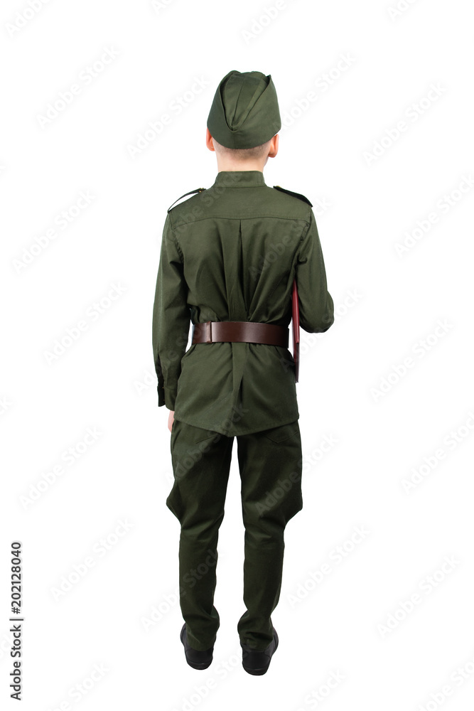child in military uniform, stands with his back and holds in his hand an oath book, in front of a white background