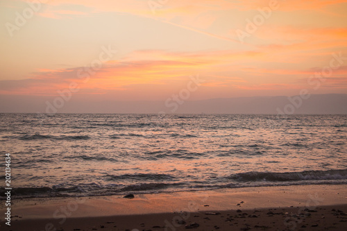Orange sunset over the sea and wave. Nature composition