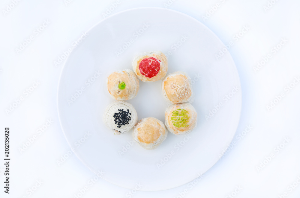 Spring roll pastry with nuts and salted eggs, chinese pastry on white plate. Spring roll pastry with nuts and salted eggs, chinese pastry on white plate.