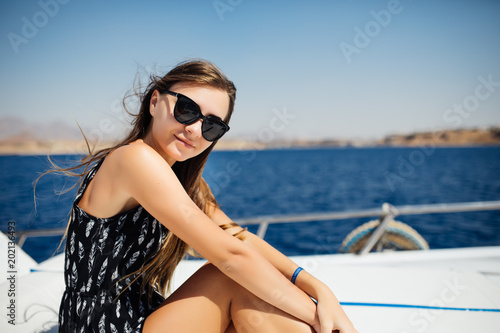 Young beauty woman lying on a private yacht in the sea © F8  \ Suport Ukraine