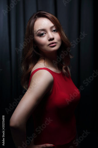 Fashionable young beautiful woman in a red dress