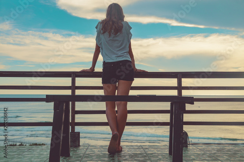 Female looking at the distant ocean / sea view. © astrosystem