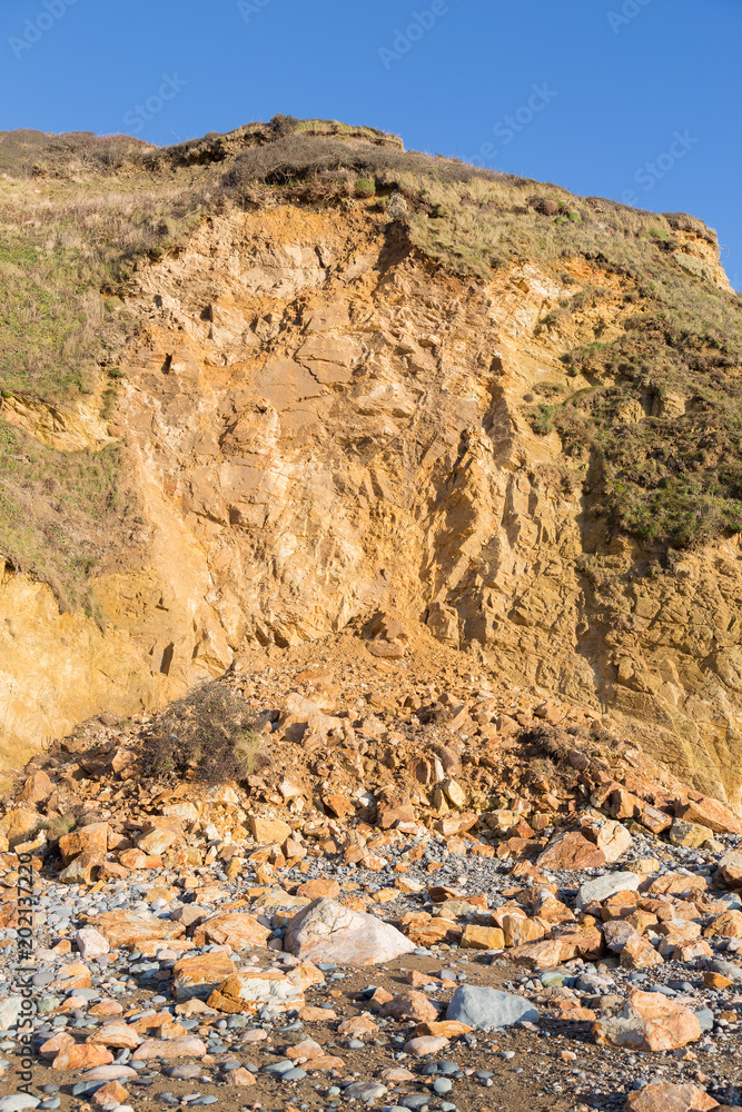 Huge pile of rock fallen from a cliff due to coastal erosion