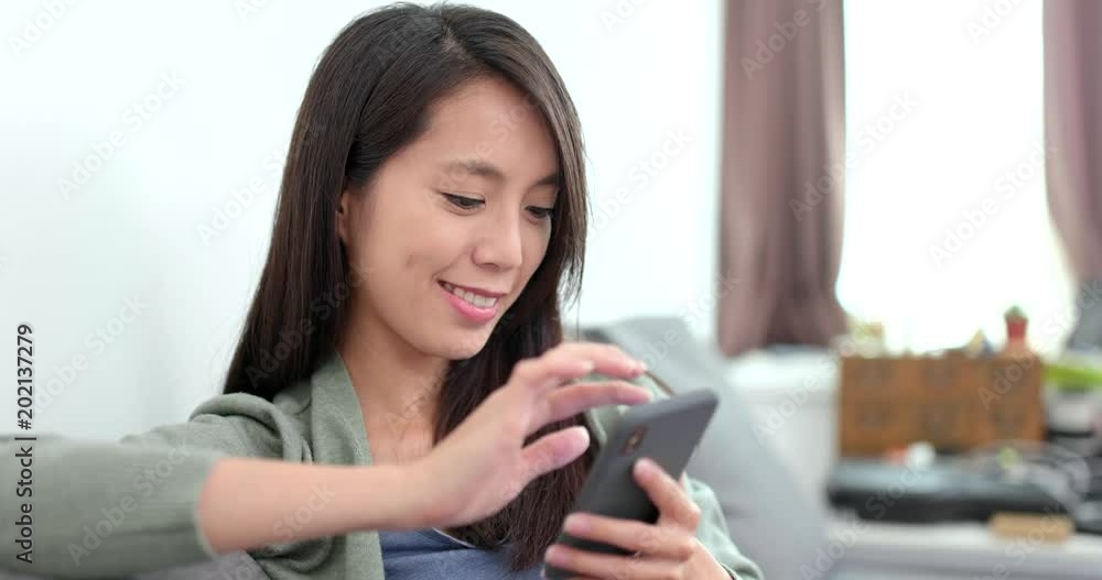 Housewife using smart phone at home Housewife using smart phone at home