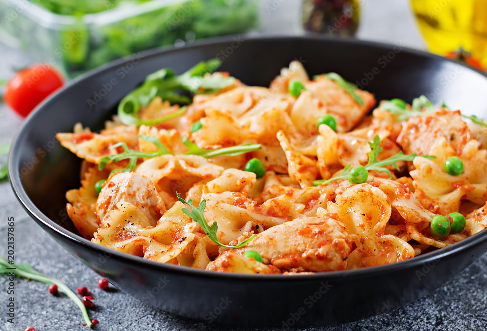 Farfalle pasta with chicken fillet, tomato sauce and green peas. Food menu Farfalle pasta with chicken fillet, tomato sauce and green peas. Food menu