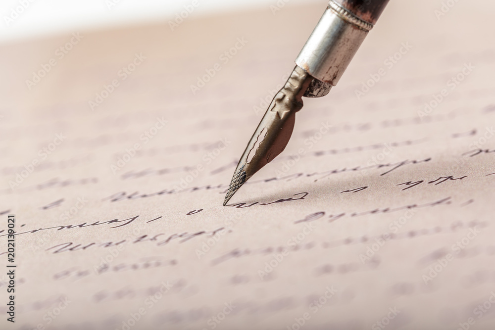Fountain pen on an antique handwritten letter Fountain pen on an antique handwritten letter
