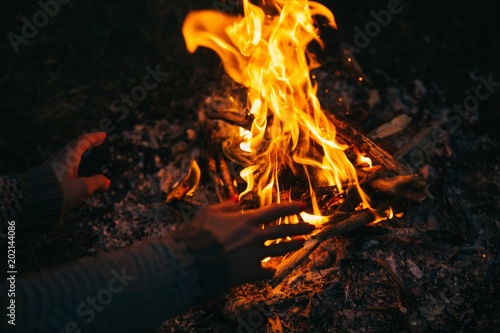 Traveler warming his hands ...