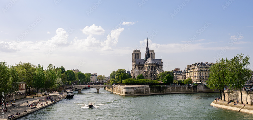Panoramic view of ile de la Cité and the Seine with Notre Dame de Paris cathedral in the distance during sunset