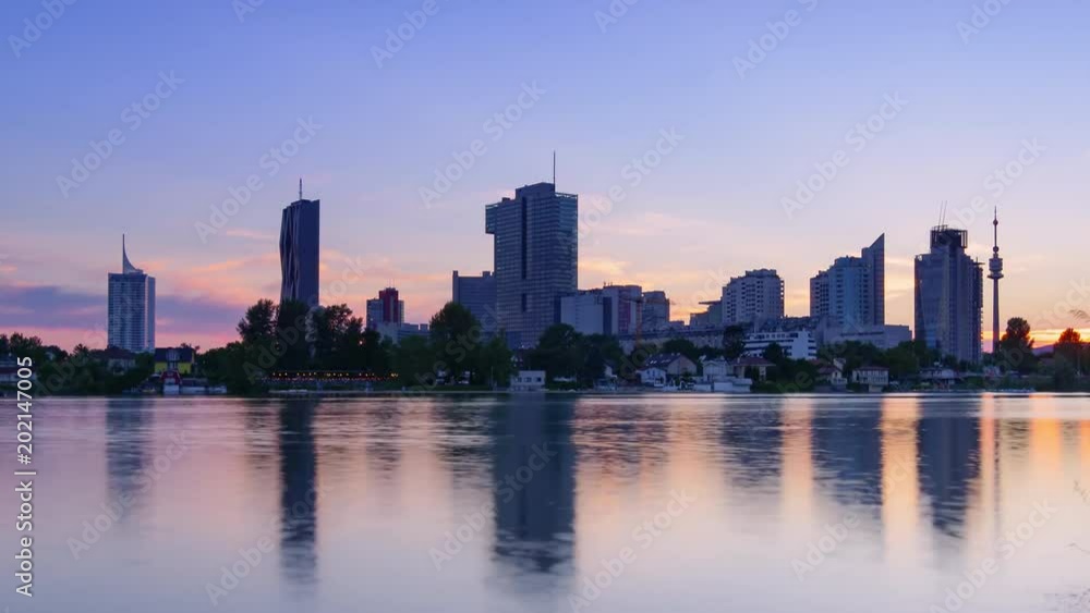 vienna time lapse at sunset sun going down behind skyscrapers on danube river vienna time lapse at sunset sun going down behind skyscrapers on danube river
