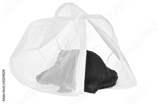 Wash bag for delicate clothes, shoes, underwear, bra. A laundry bag made of white mesh filled bras.