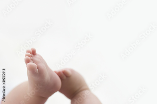 baby feet on white blanket. copy space. selective focus