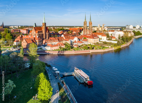 Poland. Wroclaw. Ostrow Tumski, Gothic cathedral of St. John the Baptist,  Collegiate Church of the Holy Cross, Archbishop's palace, tourist harbor, ship and Odra (Oder) River. Aerial view at sunset