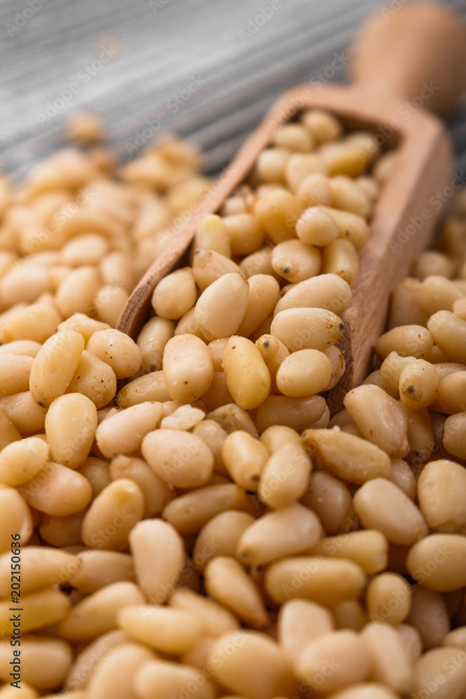 peeled pine nuts on a rustic background peeled pine nuts on a rustic background