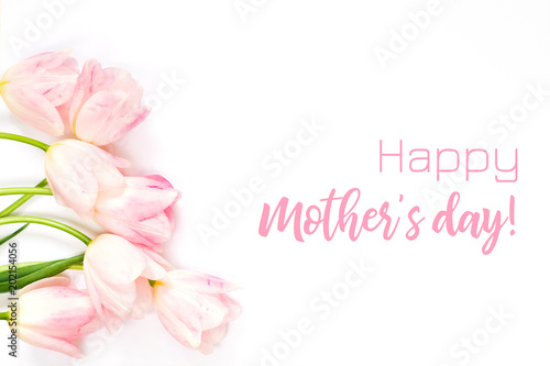 Happy mother's day greeting card with tender pink tulips on white background. Top view.