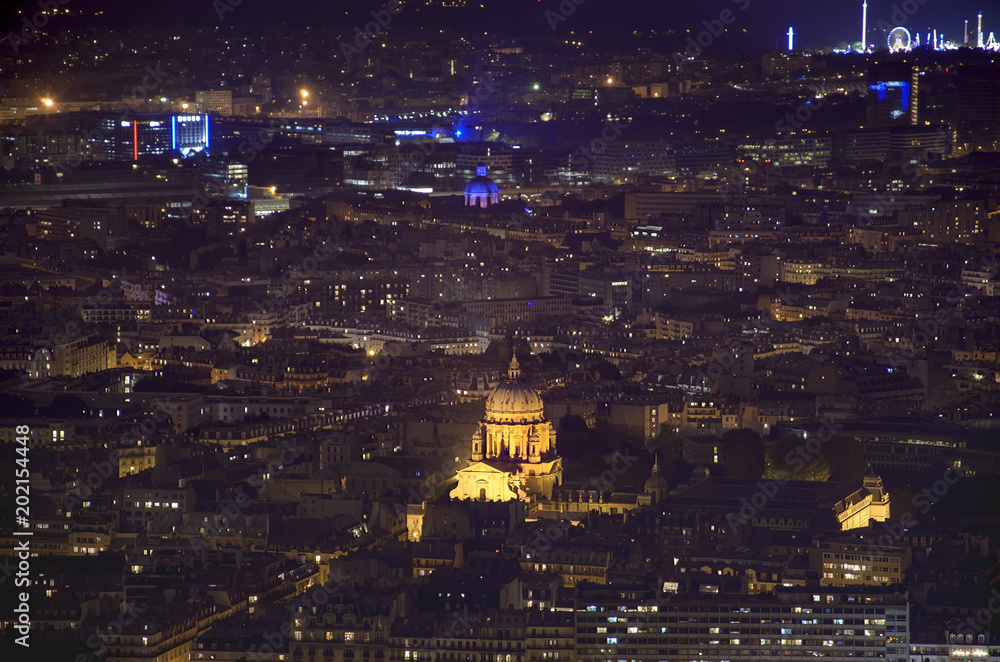 Paris, France - aerial city view with Church of Val-de-Grace illuminated at night. UNESCO World Heritage Site
