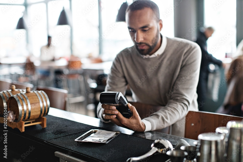 Man paying by card in restaurant Man paying by card in restaurant