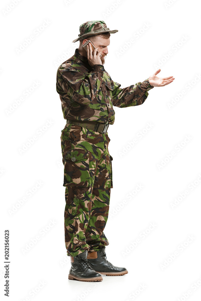 Young army soldier wearing camouflage uniform isolated on white Young army soldier wearing camouflage uniform isolated on white