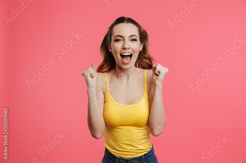 Happy screaming brunette woman in casual clothes rejoices