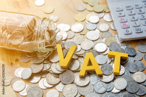 Vat Concept.Word vat put on coins and calculator on table. photo
