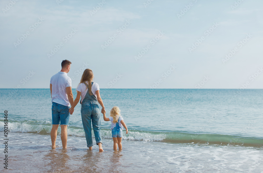 Fsmily with small kid and pregnant mom having vacation at warm sea beach or ocean Fsmily with small kid and pregnant mom having vacation at warm sea beach or ocean