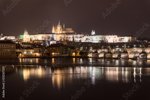 Stunning night view of the Prague castle and the famous Charles bridge over the vltava river in Prague,  Czech Republic capital city.