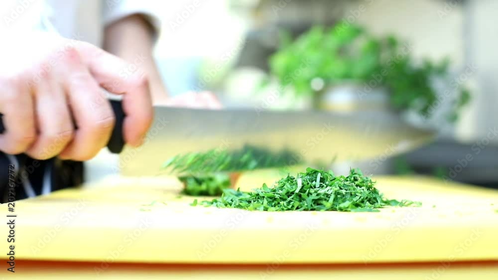 Chef slices greens for cooking in a restaurant
Chef slices greens for cooking in a restaurant