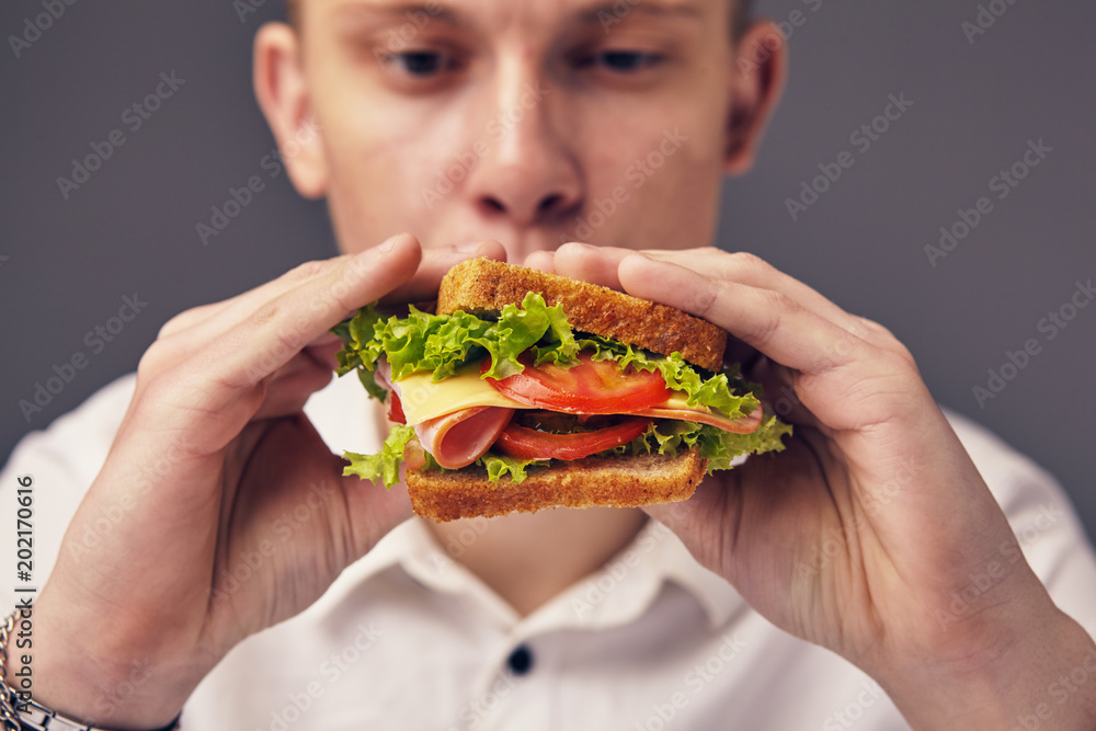 Young man looking at a fresh burger