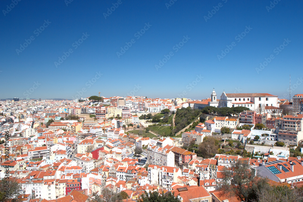 Ancient white houses with red roofs of the old town of Lisbon, Portugal