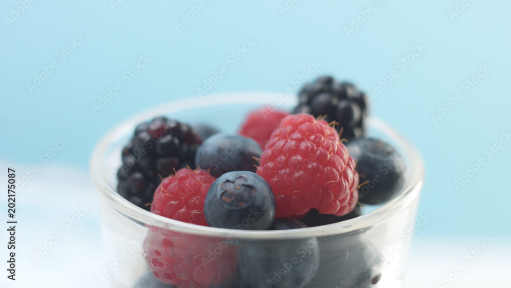 glasses with greek yogurt with berries Minimalism food on blue background. Panna cotta with strawberry raspberry, blueberry glasses with greek yogurt with berries Minimalism food on blue background. Panna cotta with strawberry raspberry, blueberry