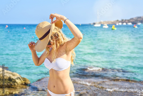 Happy Woman at the beach in Cyprus. Beautiful Summer seaside view. Enjoying s...