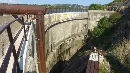 Dam wall with blue water of the reservoir photo