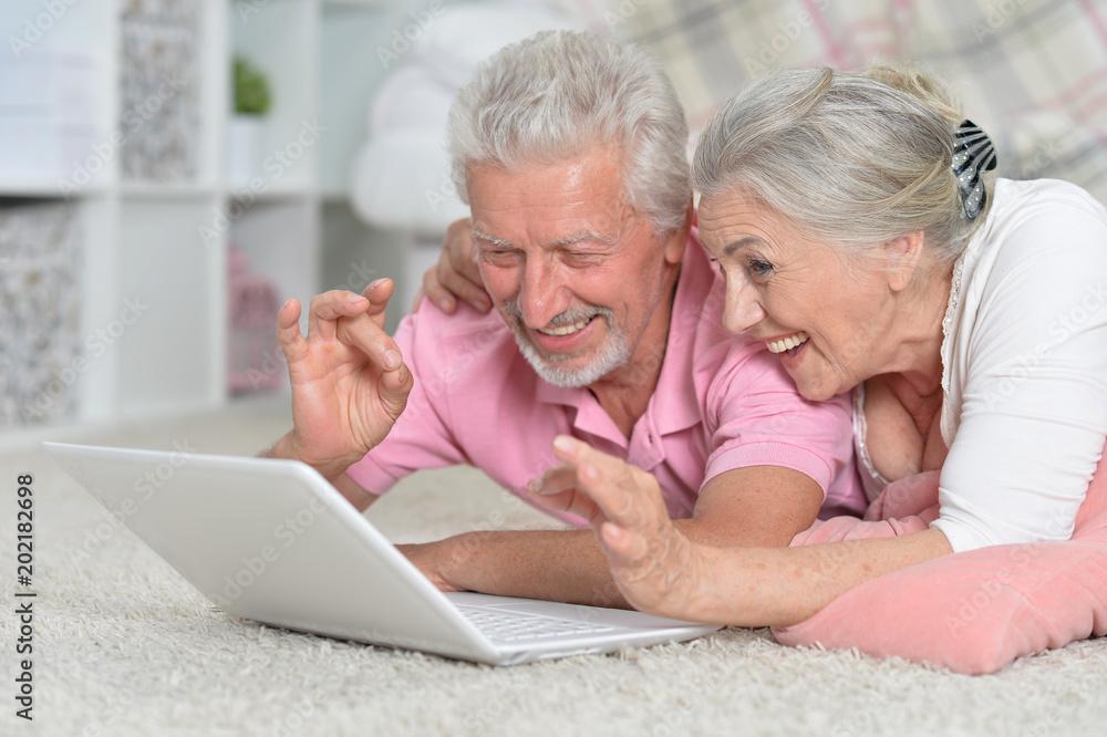 senior couple using laptop senior couple using laptop