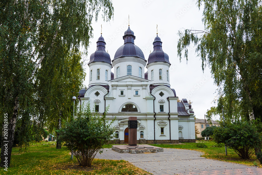 Temple of St. Peter Kalnyshevsky in Nedryhailiv, Sumska oblast, Ukraine. Beautiful white building with domes for religious purposes, Orthodox Church.