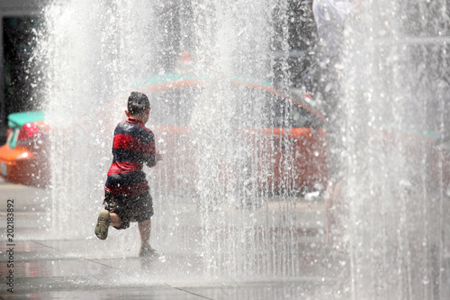 Fototapeta Naklejka Na Ścianę i Meble -  Playing in the Water Fountain - Toronto, Canada