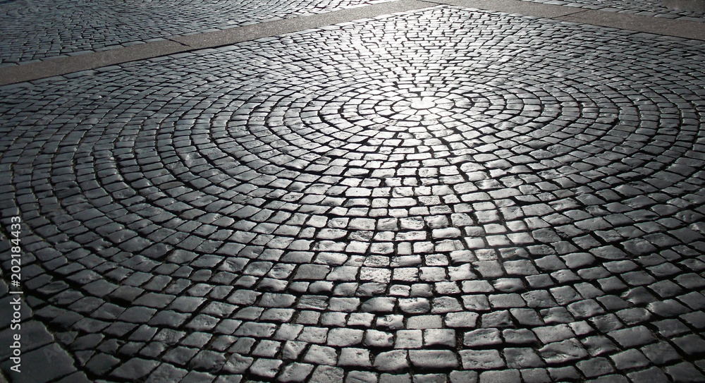 Pavement of the palace square with backlighting of the sunlight. Texture and background.