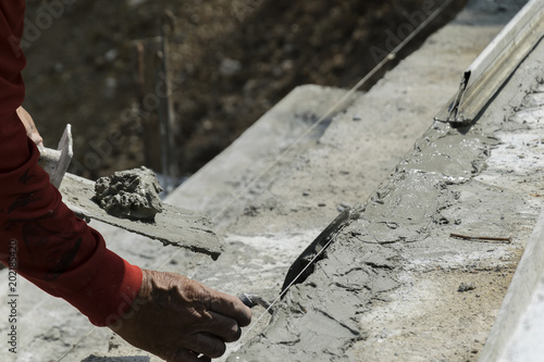 Hands Plasterer at work. Application of the textured plaster