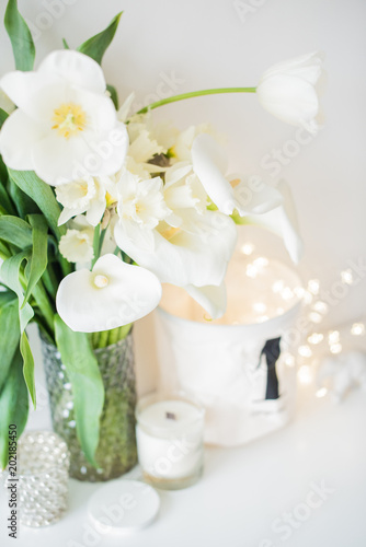 Large bouquet of white spring flowers in a vase  daffodils  tuli