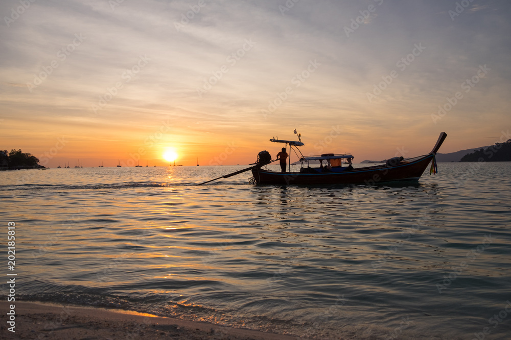 Beautiful view of Koh Lipe Island,Thailand. Silhouette sunset sky and longtail boat.