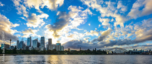 Wide panorama of Sydney, Australia with amazing sunset and clouds over the city skyline and Botanic Gardens