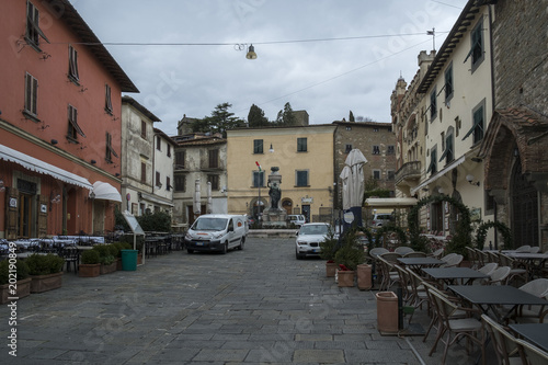 MONTECATINI ALTO, ITALY - FEBRUARY 2018; Medieval buildings on central city square surrounded with street cafe and small shops photo