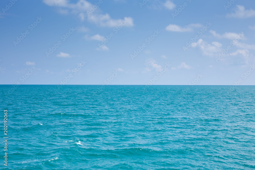 Fototapeta premium Beautiful white clouds on blue sky over calm sea