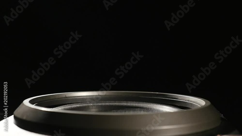 Close-up at moving sub-woofer. Speaker sub-woofer moving from loud music