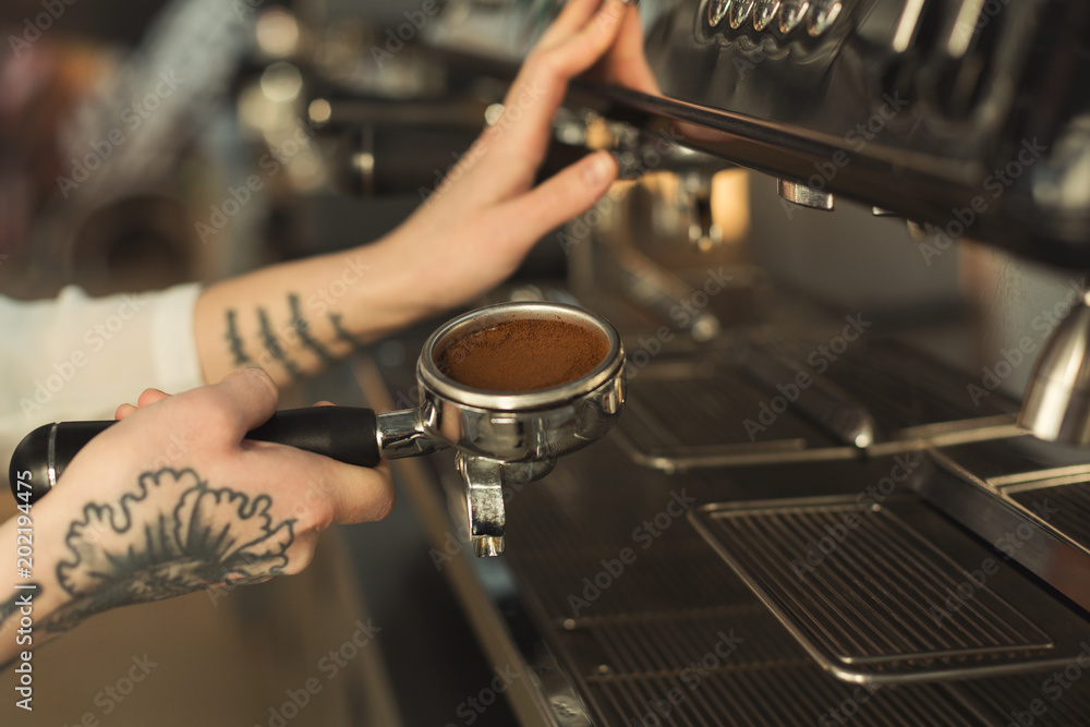 Closeup of barista hand making coffee in professional coffee machine