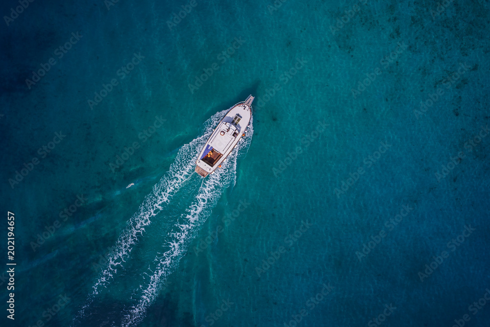 Fototapeta premium Vintage wooden boat in coral sea. Boat drone photo.