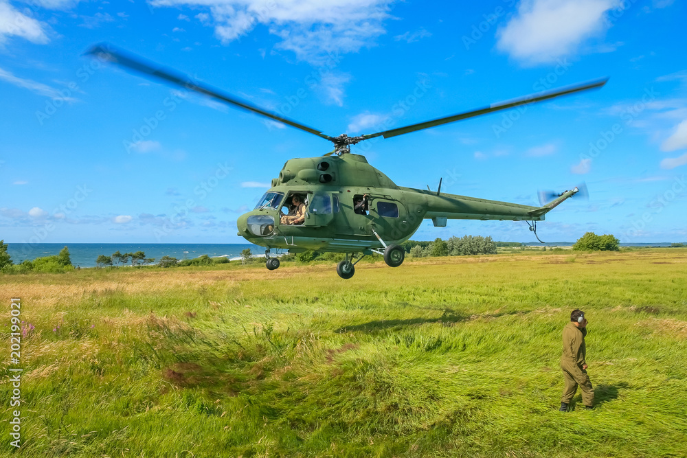 The military sends a helicopter contract up or down the ground. Helicopter landed. Poland The military sends a helicopter contract up or down the ground. Helicopter landed. Poland