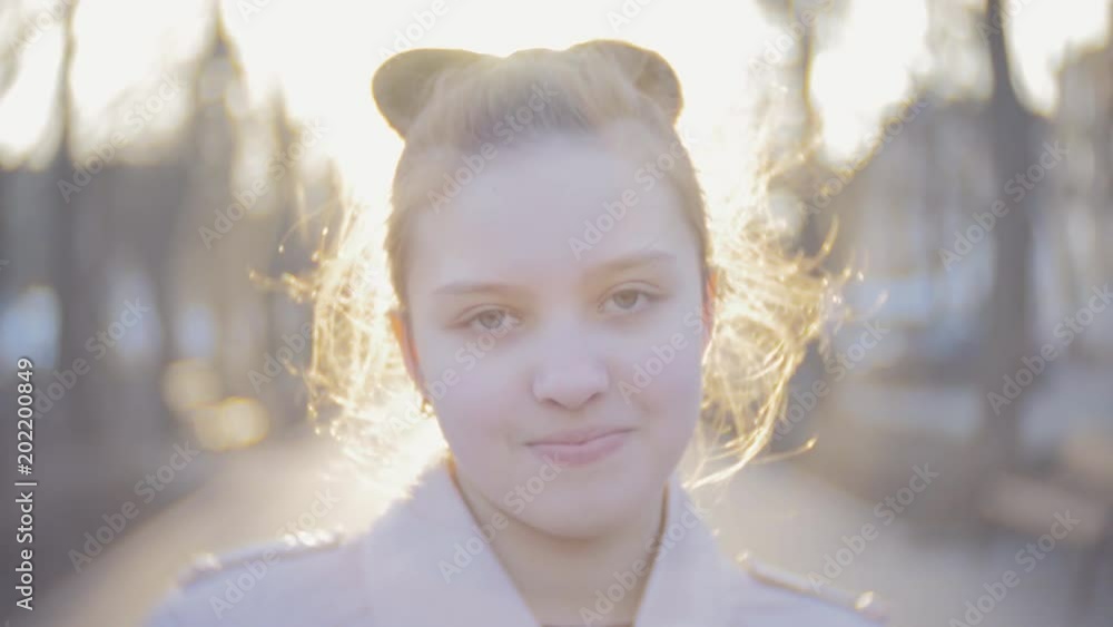Portrait of an attractive young teen girl looking at the camera and smiling. Close shot Portrait of an attractive young teen girl looking at the camera and smiling. Close shot
